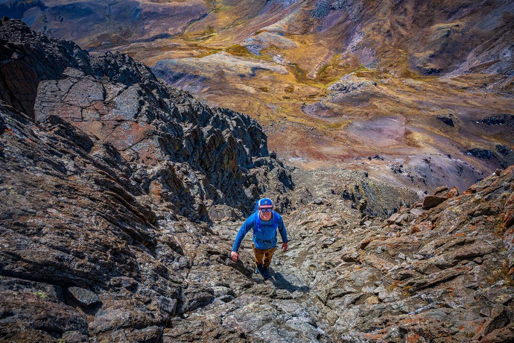 A man hikes the trail to Wetterhorn Peak, a 14er (14,000+-foot mountain) near Lake City, Colorado.